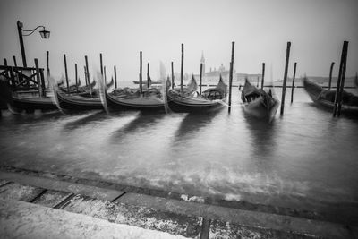 Boats moored in water