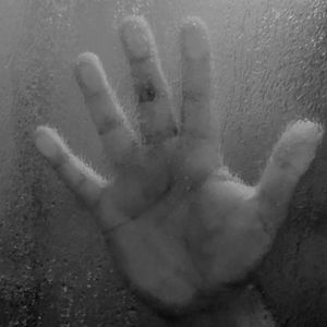 Close-up of hands on glass