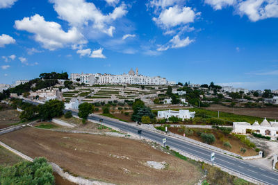 High angle view of city against cloudy sky