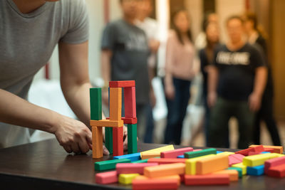 Rear view of people playing with text at table