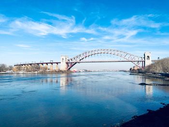 View of bridge over river against cloudy sky