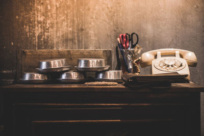 Old-fashioned telephone on table against wall