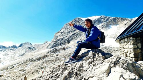 Full length of man standing on mountain against sky