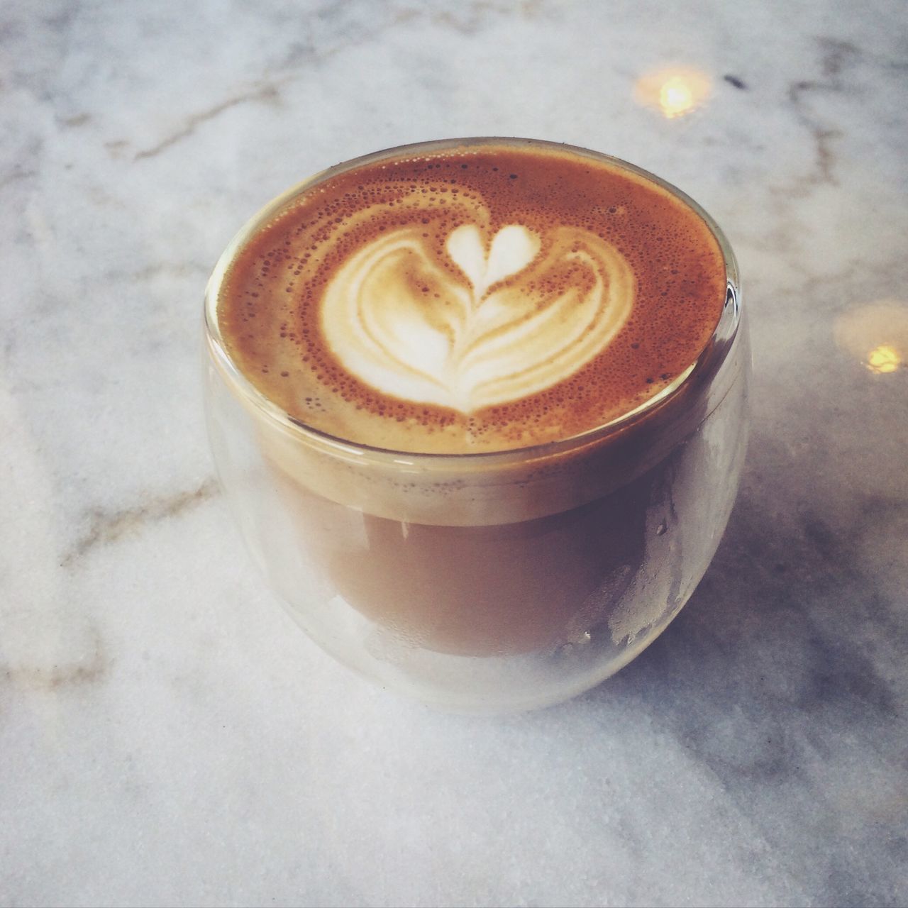 drink, froth art, refreshment, coffee cup, frothy drink, cappuccino, food and drink, coffee - drink, table, saucer, close-up, high angle view, heart shape, art, still life, creativity, indoors, art and craft, coffee, love