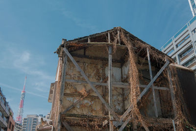 Low angle view of ruined building against sky