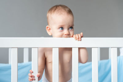 Portrait of cute baby boy sleeping on bed at home