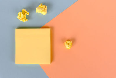 Directly above shot of yellow paper on table