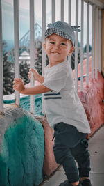 Portrait of smiling boy standing outdoors