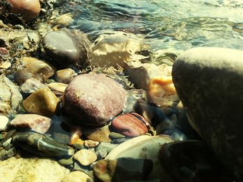 High angle view of pebbles on shore