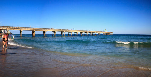 Deerfield beach pier under a blue sky in deerfield, florida