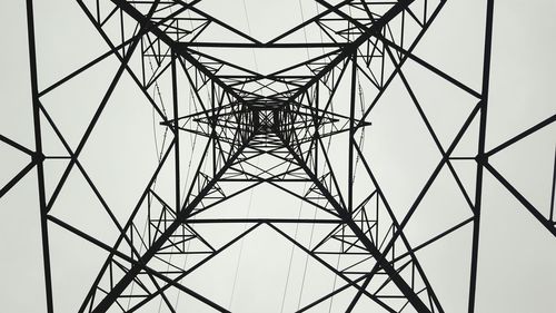 Low angle view of electricity pylon against sky