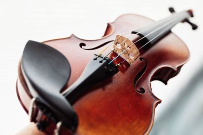 Close-up of violin over white table