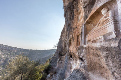 Low angle view of rock formation against sky