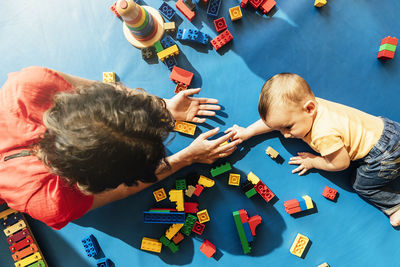 High angle view of people playing with toy on table