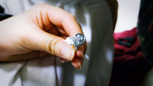 Cropped hand of woman holding paper rose