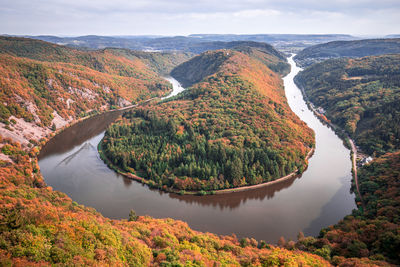 High angle view of river amidst trees against sky