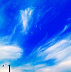 Low angle view of vapor trail in blue sky