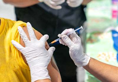 Woman with face mask getting vaccinated, coronavirus, covid-19 and vaccination concept person