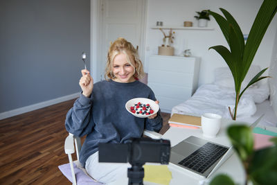 Portrait of cute girl using mobile phone on table