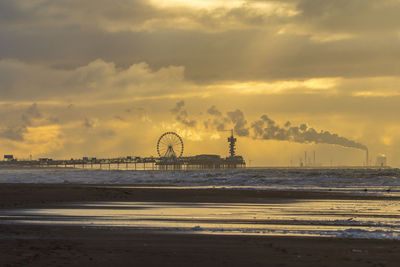 Scenic view of beach against sky during sunset