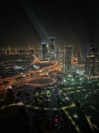 High angle view of illuminated buildings in city at night