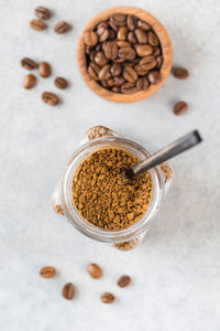 A jar with instant coffee and a spoon inside top view.