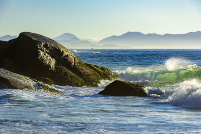 Scenic view of sea against clear sky at morning