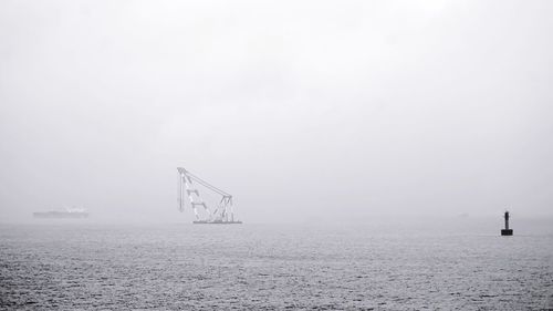 Scenic view of sea against sky during foggy weather