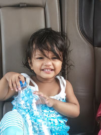 Portrait of smiling girl inside the car.