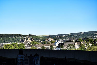 Aerial view of townscape against clear blue sky