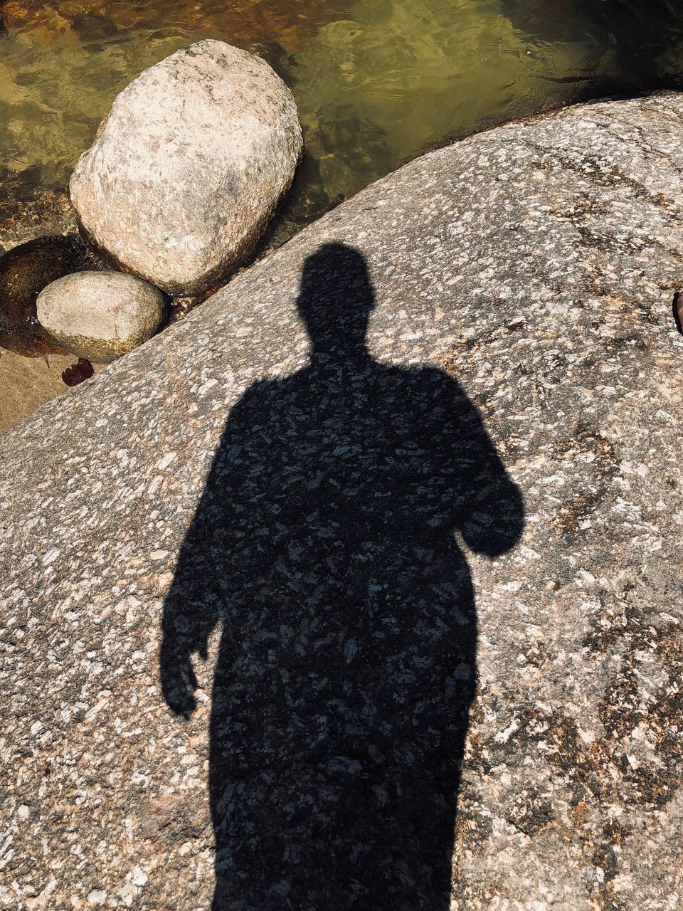 SHADOW OF PEOPLE ON ROCK