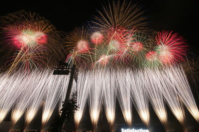 Low angle view of firework display at night