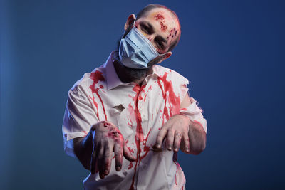 Rear view of man wearing mask against black background