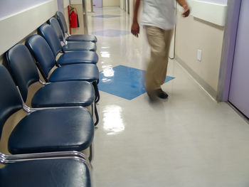 Low section of man walking in corridor of building