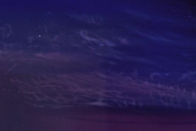 Defocused image of landscape against sky at night