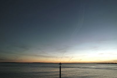 Scenic view of sea against sky at sunset