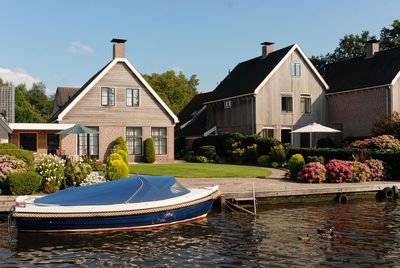 Houses by building against sky