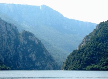 Scenic view of river amidst mountains against sky