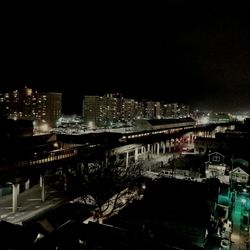 High angle view of illuminated buildings in city at night