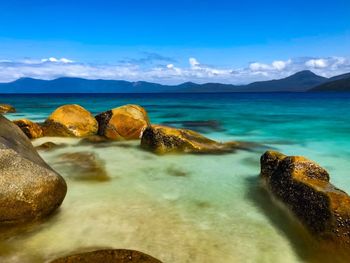 Rocks in sea against sky