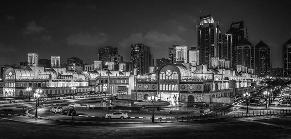 View of illuminated buildings against sky at night