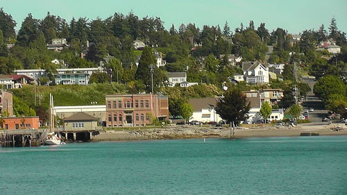 Houses by sea against sky