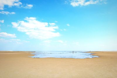 View of beach against cloudy sky