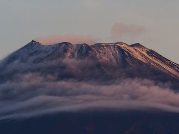 Scenic view of mountains against cloudy sky