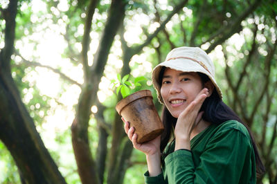 Portrait of a smiling young woman in forest