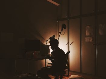Silhouette of man playing piano