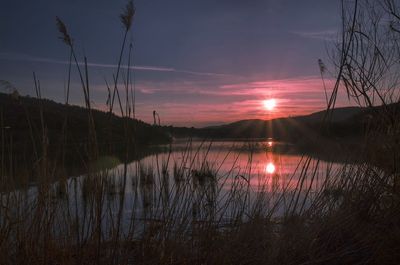 Scenic view of calm lake at sunset