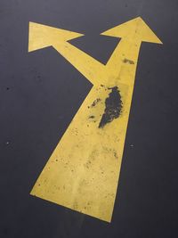 High angle view of arrow sign on road