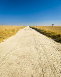 Dirt road along countryside landscape