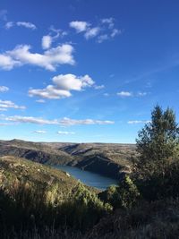 Scenic view of landscape against blue sky